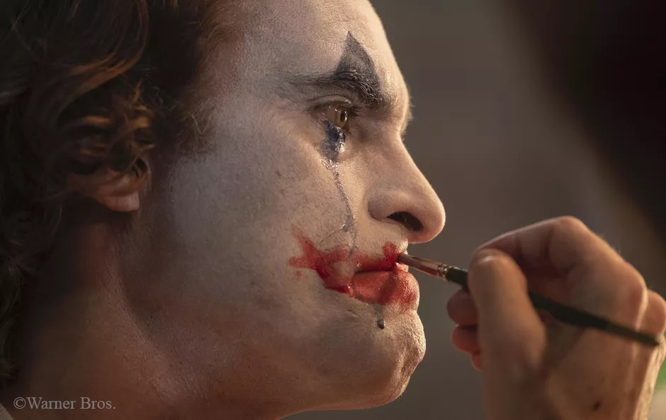 Joker applying makeup
